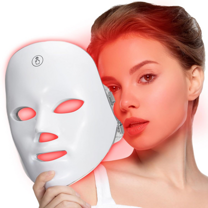 Woman holding a white LED face mask with red illumination